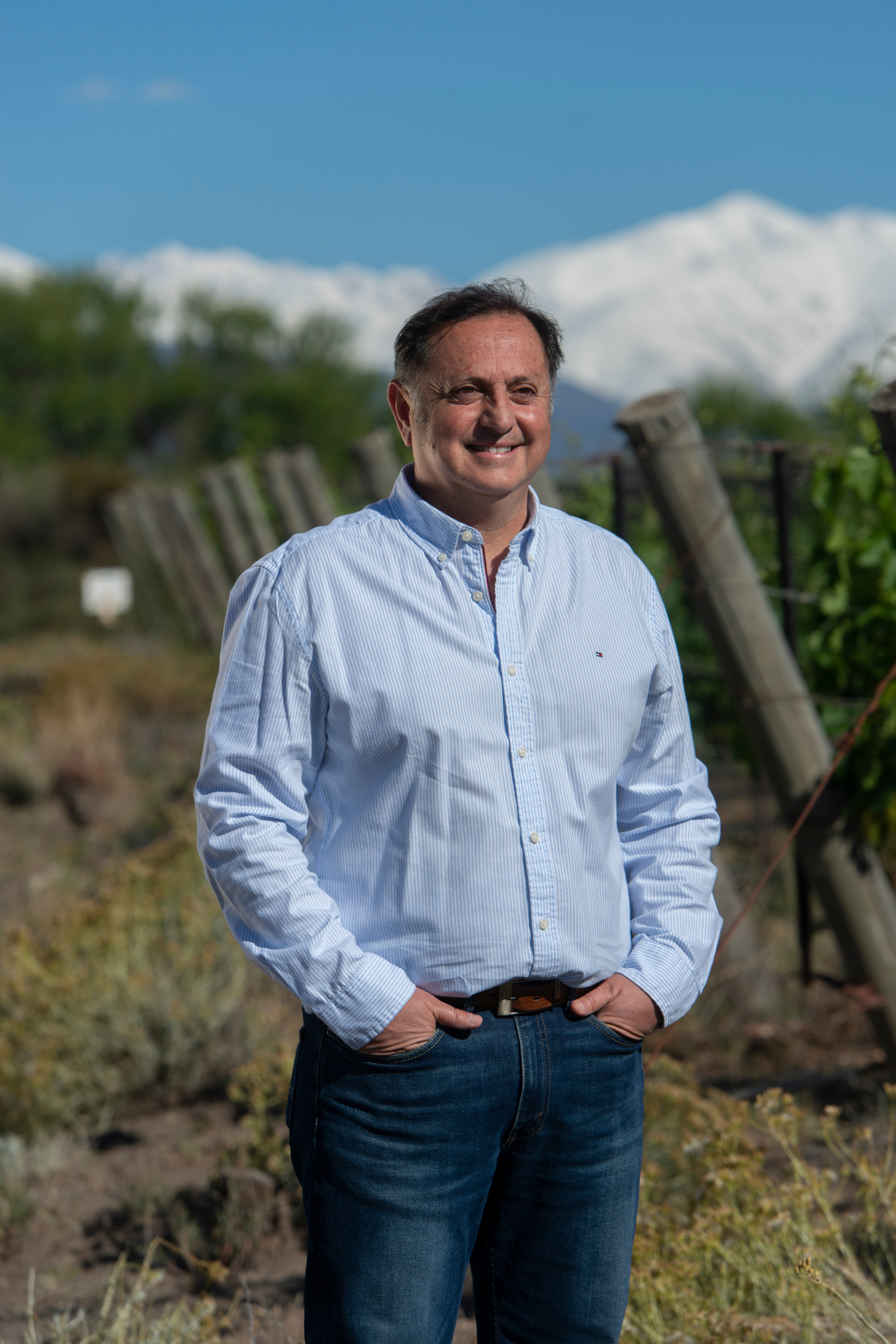 Winemaker smiling in vineyard